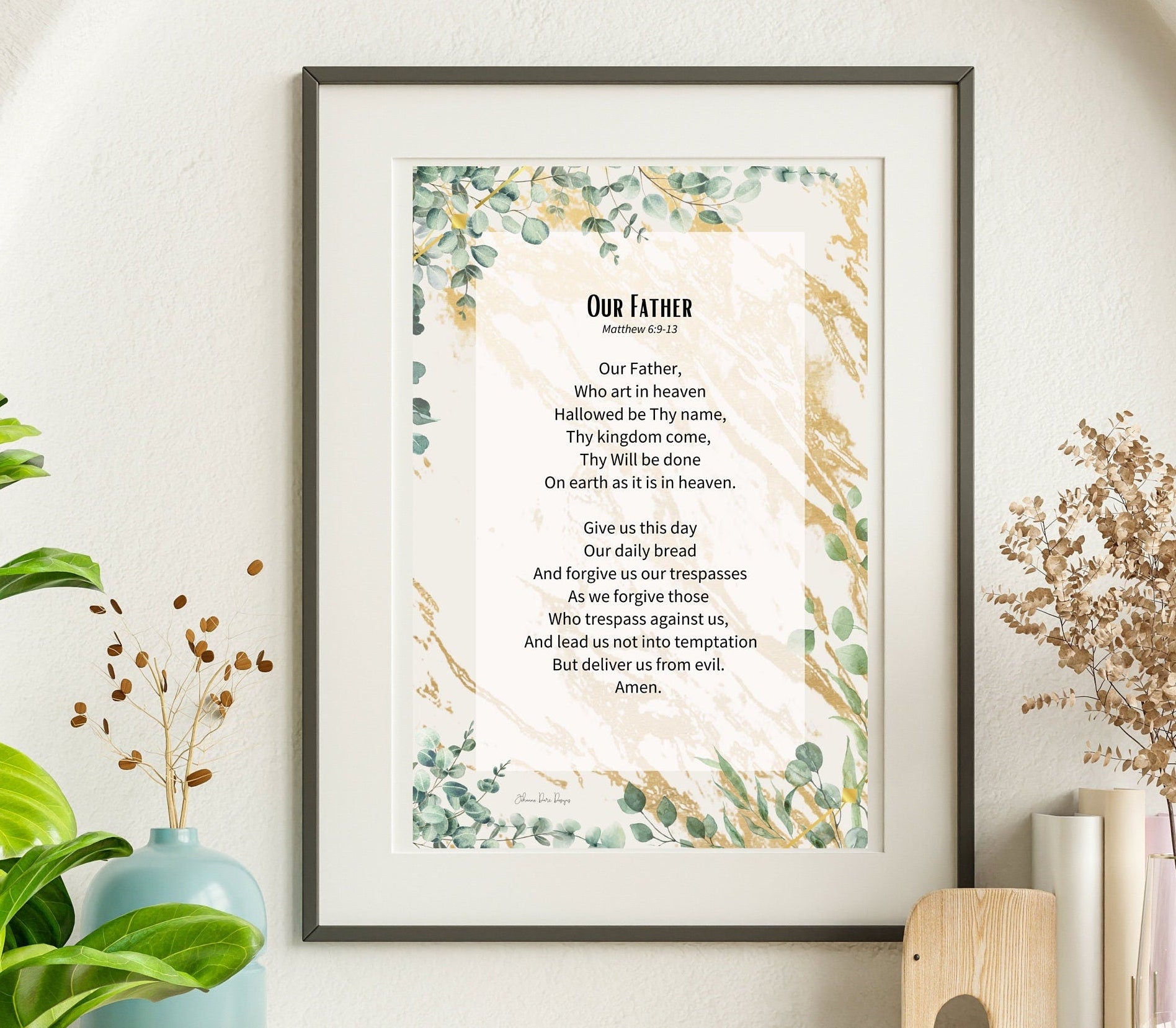 Framed print of 'Our Father' prayer on a wall with decorative elements.