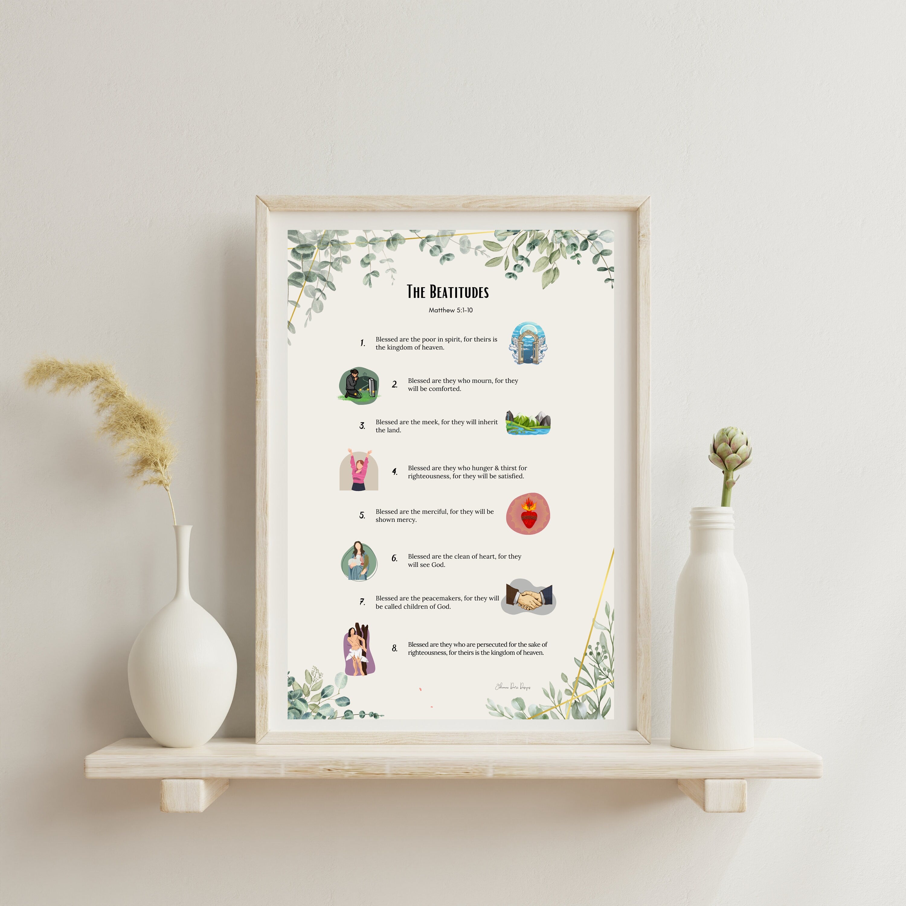 Framed print of 'The Beatitudes' with illustrations on a shelf against a light wall.
